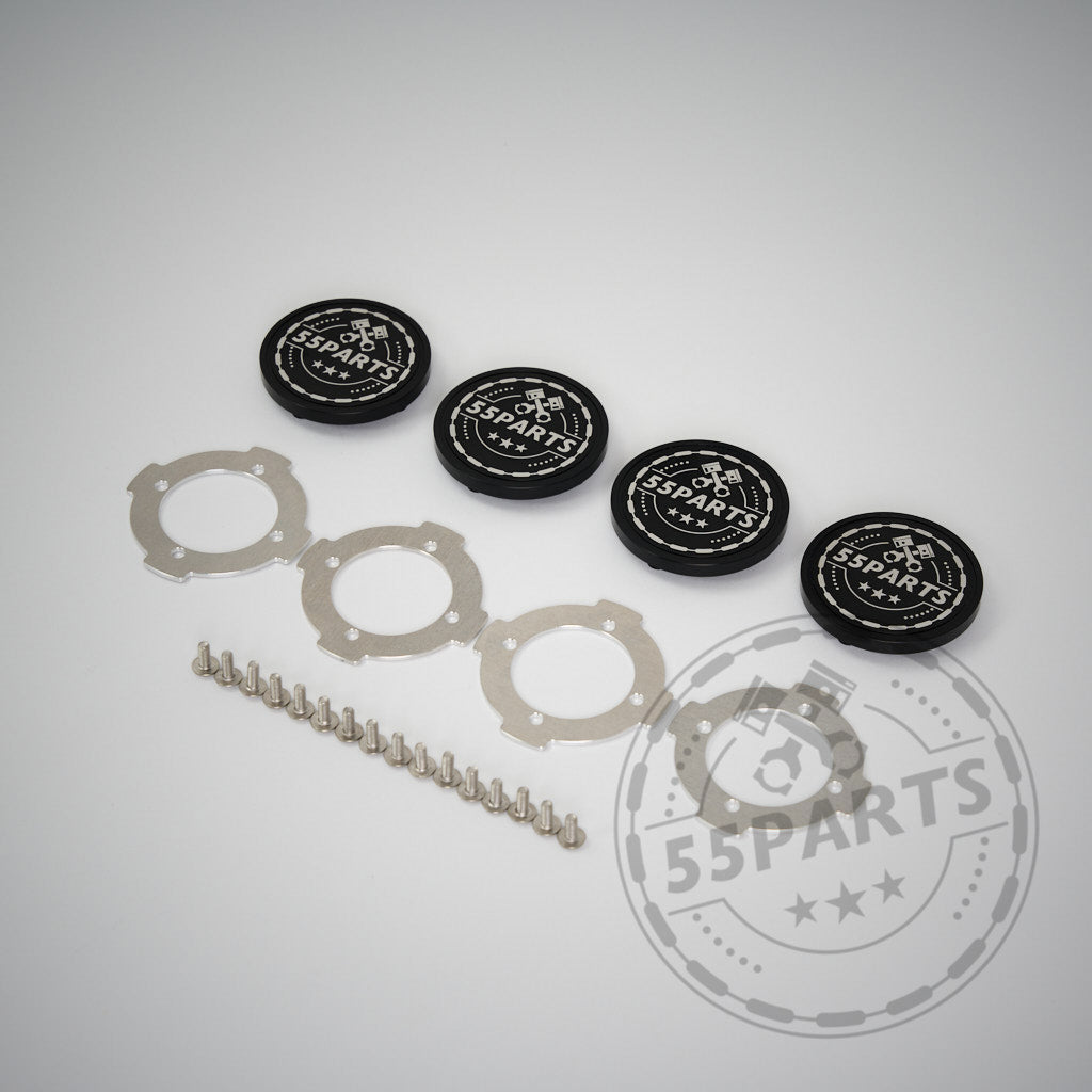 Auf hellem Untergrund sind vier schwarze 55Parts Special CNC-gefräste, verschraubte Radnabendeckel plus Metallringe und -stifte angeordnet – kompatibel mit ProTrack One Felgen und ausgelegt für Aluminiumräder.