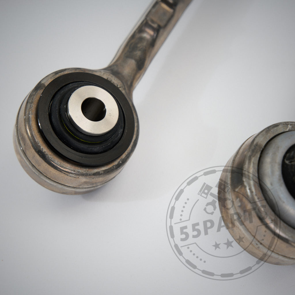 Nahaufnahme von zwei OEM-Querlenkern aus Metall mit NoFlex-Lagern passend für BMW 1er, 2er, 3er, 4er F-Serie (F2x, F3x) inkl. xDrive Modelle ALLE MOTOREN auf weißer Oberfläche, mit sichtbarem 55Parts-Wasserzeichen.