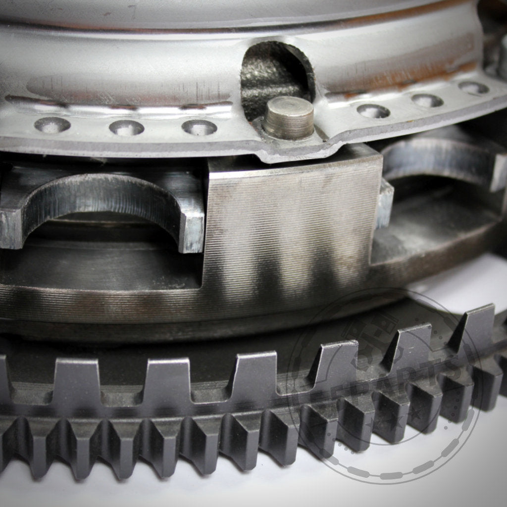 Die Nahaufnahme der bearbeiteten Metallzahnräder zeigt die Präzision der 55Parts-Exklusiv-Zweischeibenkupplung inkl. EMS passend für BMW M50, M52, M54, S52, S54 und unterstreicht die verbesserte Haltbarkeit und Qualitätstechnik.