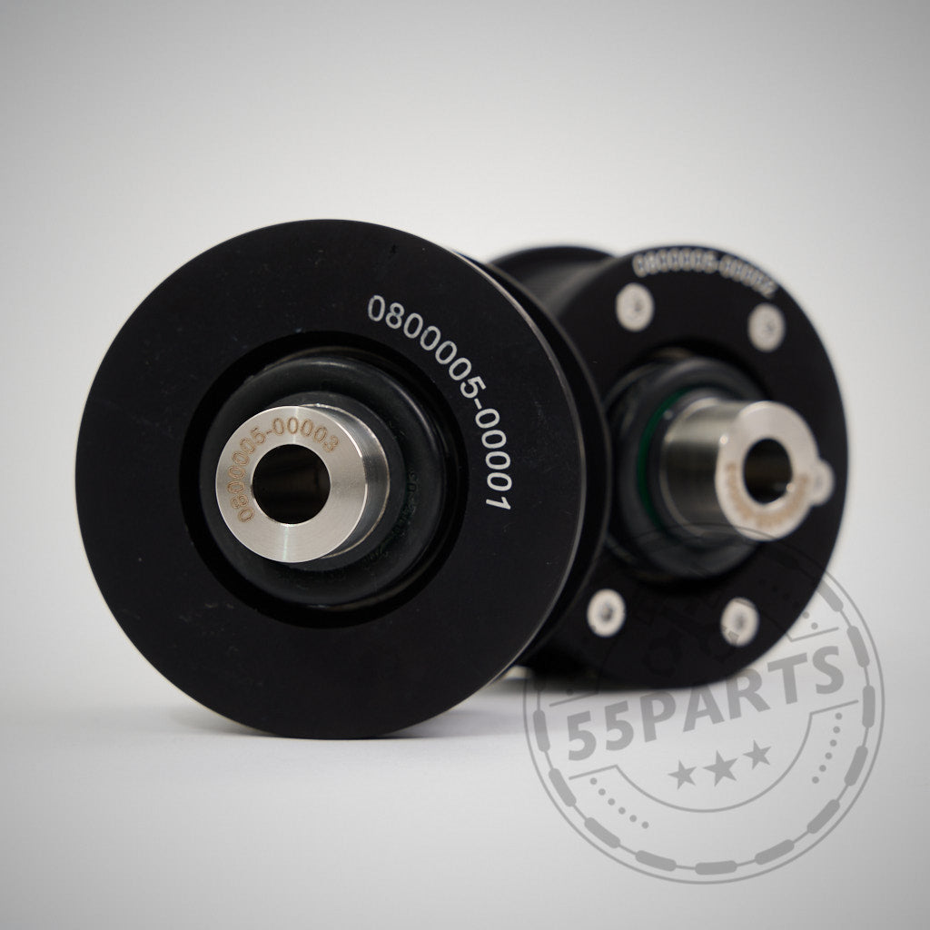 Zwei schwarze NoFlex-Lager (Uniball-Lager) aus Metall passend für BMW 2er/3er/4er-Reihe, Z4 G-Reihe inkl. xDrive und alle Toyota Supra GR-Motoren; mechanische Teile mit Seriennummern auf weißer Oberfläche für Fahrwerk-Modifikationen.