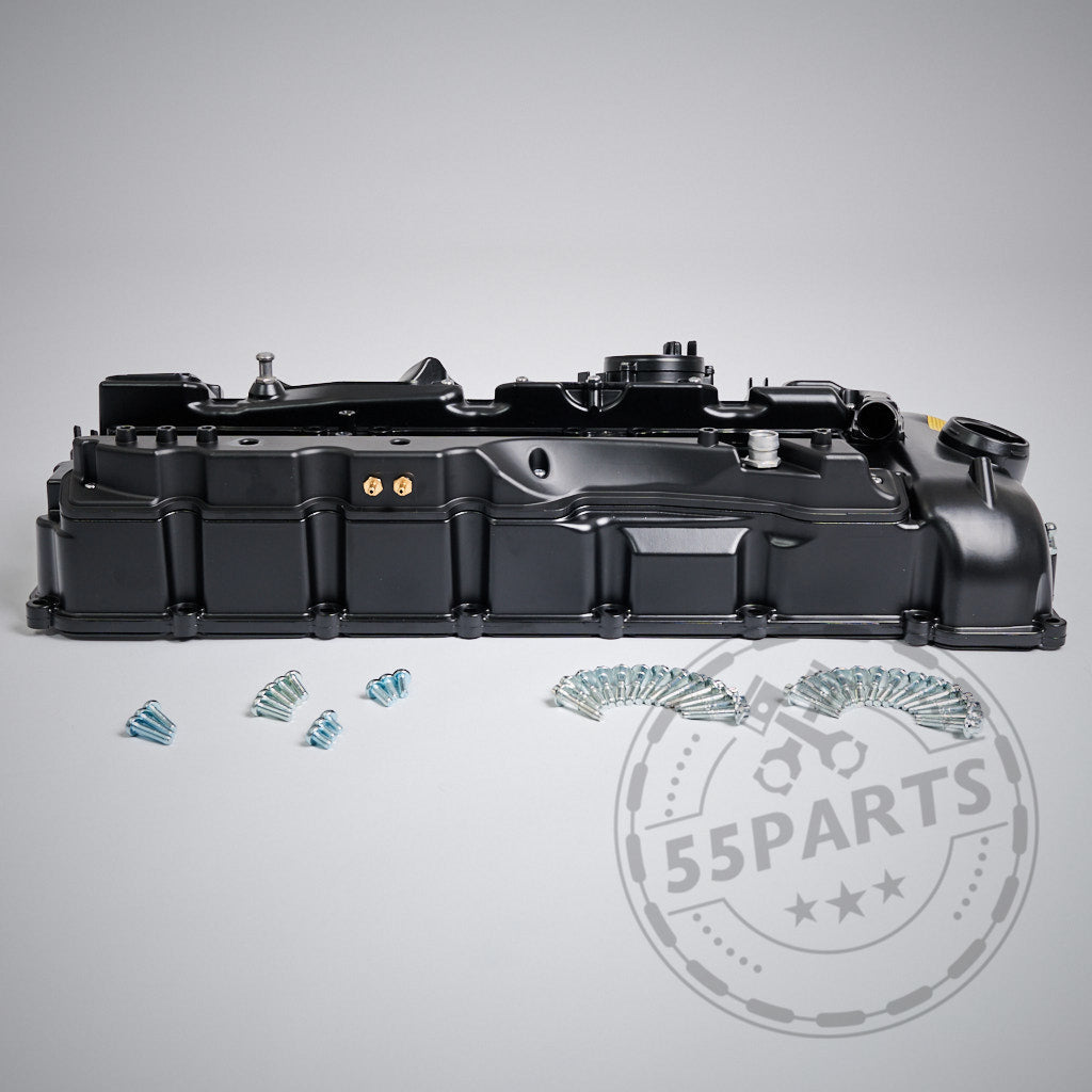 55Parts EXKLUSIV: Schwarzer Aluminium-Ventildeckel passend für BMW N55 Motor (M)135i, M235i, 335i, 435i, 535i, 640i mit frontseitig angeordneten Schrauben auf grauem Hintergrund und einem 55Parts-Wasserzeichen.