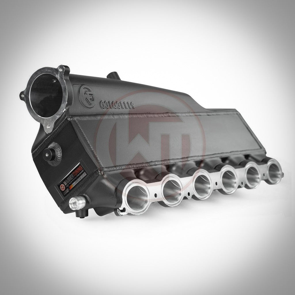 Die 55Parts Wagner Ansaugbrücke mit integriertem Ladeluftkühler EVO1 für F2X 1er/2er, F3X 3er/4er B58 verfügt über ein schwarzes Aluminiumgehäuse mit sechs silbernen Ansaugöffnungen, dargestellt auf weißem Hintergrund – eine echte Tuning-Ikone.