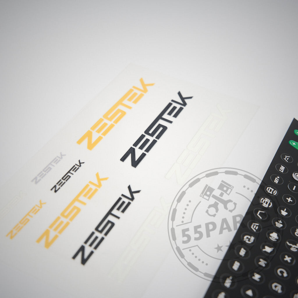 Individualisieren Sie Ihr 55Parts Exklusiv: Zestek Lenkrad HUB passend für BMW E-, F-, G-Serie, Toyota Yaris & Supra mit diesem Aufkleberbogen mit ZESTEK in Orange, Schwarz, Grau und einem runden Zestek Racing Hub-Logo – ideal für Rennlenkrad- oder Quick Release-Setups.