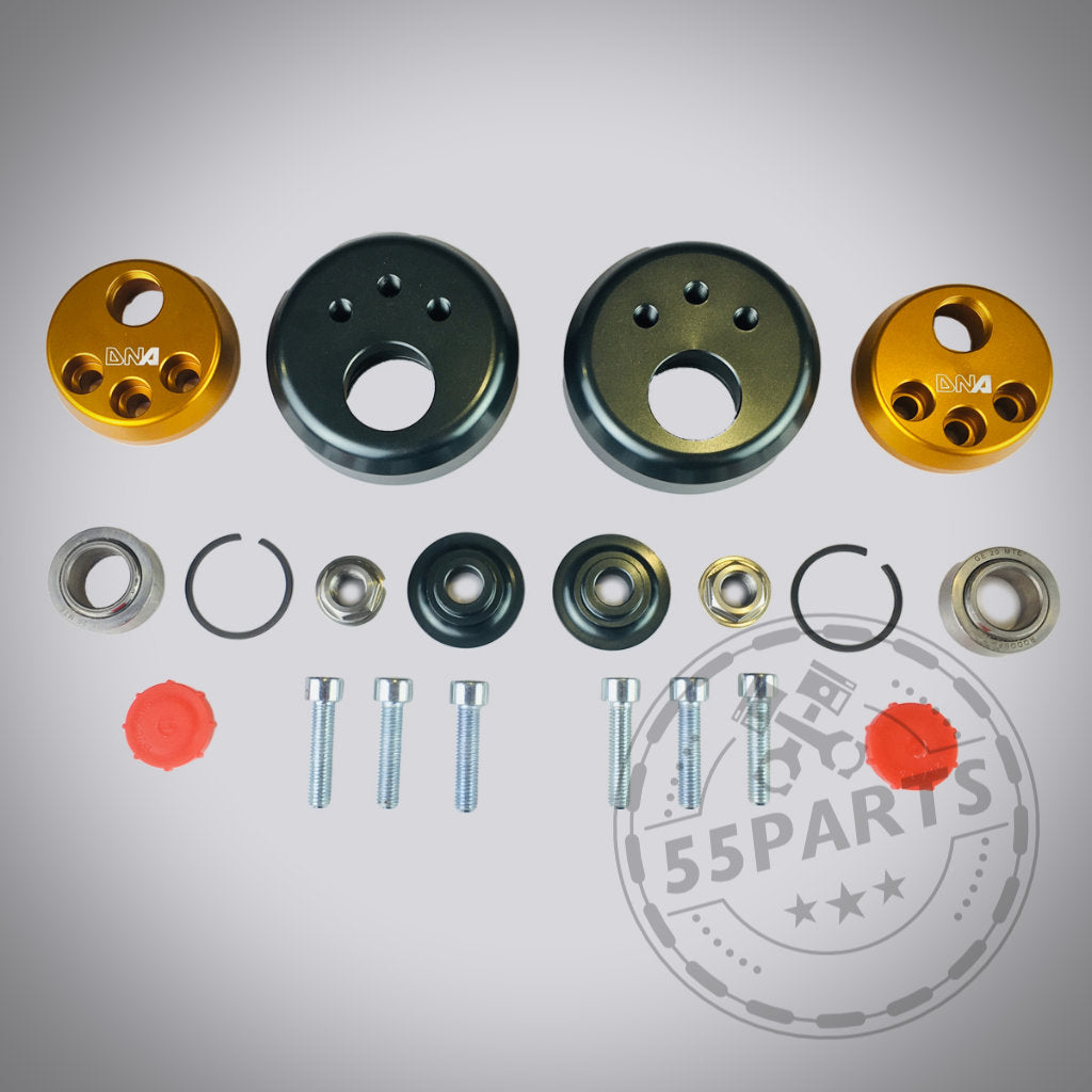 Das verstellbare Uniball-Domlager von DNA Racing für den Toyota Yaris GR mit verschiedenen mechanischen Teilen wie Schrauben, Lagern und Metallabdeckungen ist auf einem grauen Hintergrund angeordnet.