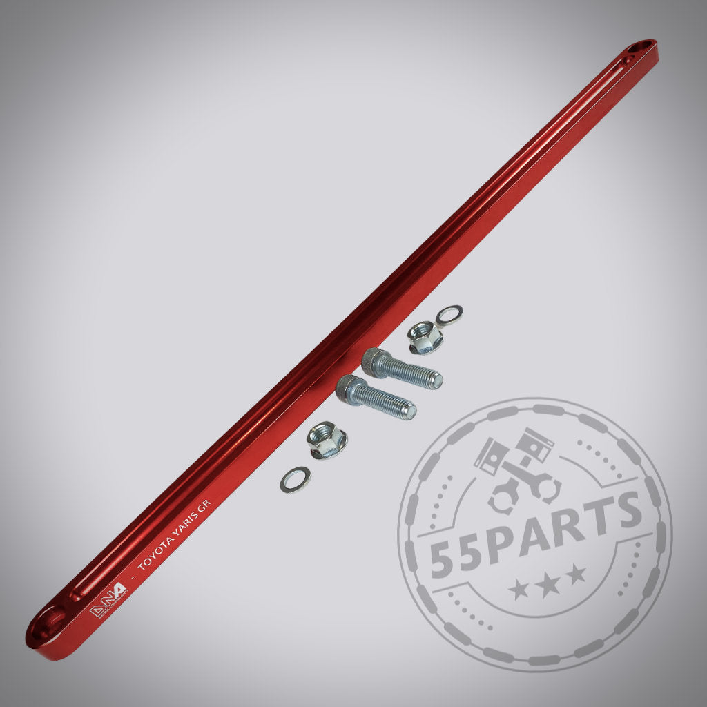 DNA Racing Versteifungsstrebe vorderer Achsträger vorne für Toyota Yaris GR, inkl. Bolzen und Unterlegscheiben, auf grauem Hintergrund präsentiert.