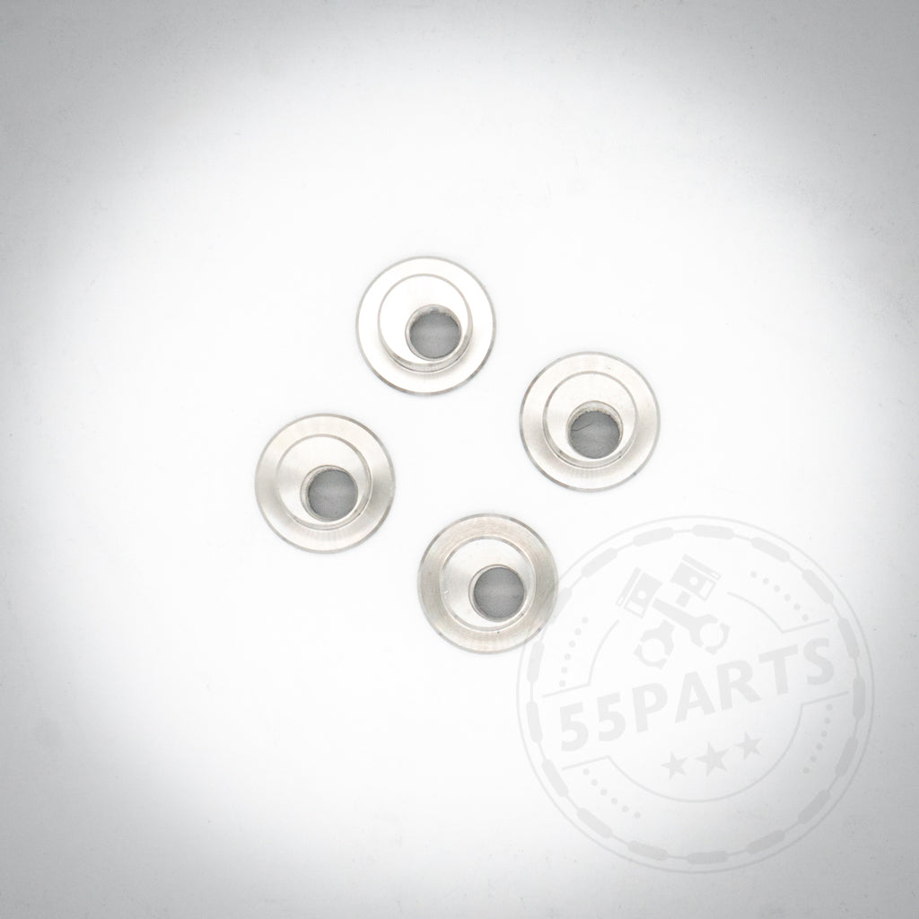 Vier Adapterbuchsen für Performance-Hinterradbremssättel, passend für BMW E36 und E46, werden auf einem weißen Hintergrund mit einem schwachen 55Parts-Logo-Wasserzeichen angezeigt.