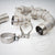 Drei 55Parts High Flow 3,5" Downpipes (Katlos oder mit 200 Zeller) für Mercedes Benz AMG C63(S) W205 M177 mit Wärmehülle und zwei Metallklemmen, ideal für Abgassystem-Upgrades, auf weißem Hintergrund dargestellt.