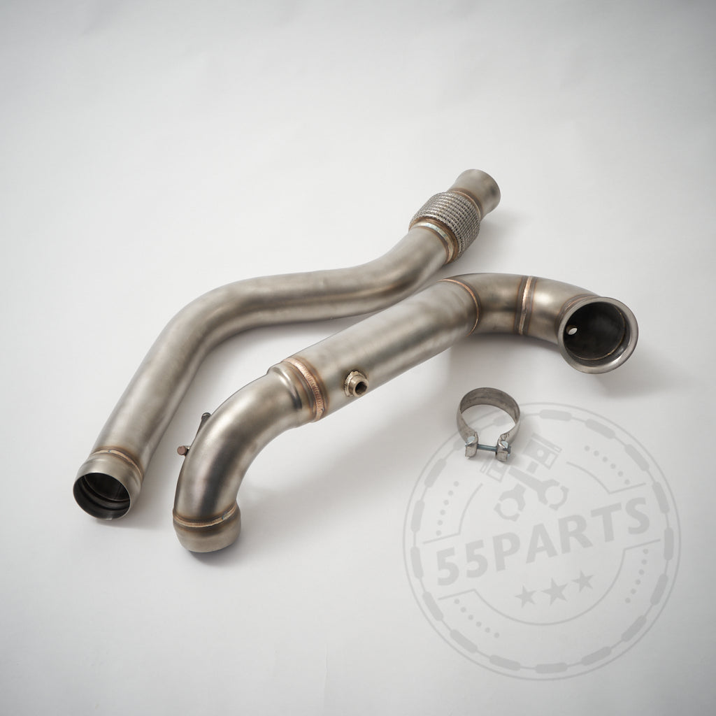 Zwei metallische Catless Downpipes und eine Schelle für Mercedes Benz AMG A45, CLA45 &amp; GLA45 (W176, C117, X156) auf weißem Hintergrund. Dahinter ist ein schwaches Logo zu sehen. Ideal für AMG-Modelle mit Turbomotoren.