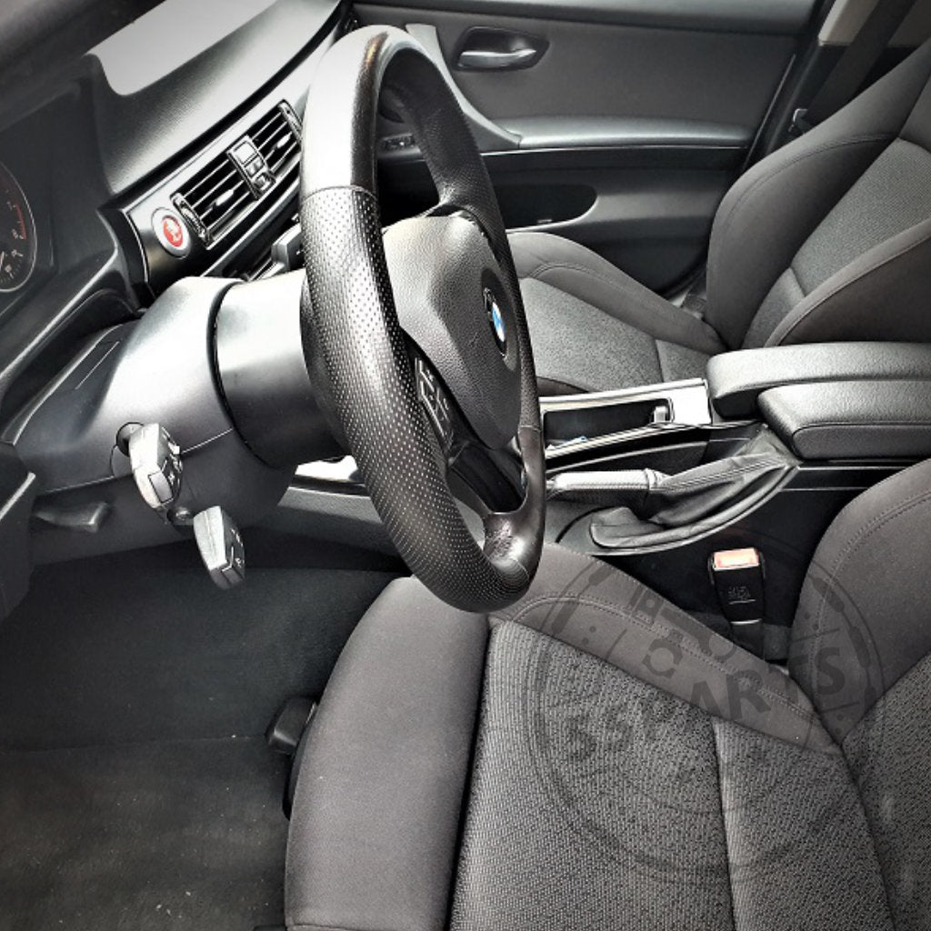 Der schwarze Innenraum eines BMW E9X M3 präsentiert den Spurverbreiterungs-/Lenkrad-Abstandshalter von DDM Racing Srls, der für alle E9X 3er und E8X 1er geeignet ist und seine Position am Lenkrad, Armaturenbrett und den Vordersitzen hervorhebt.