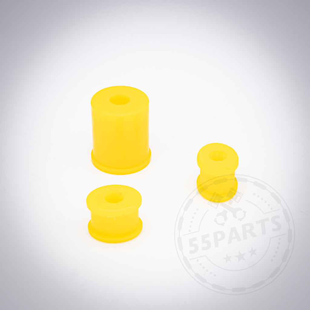 Drei gelbe PU-Polyurethan-Schalthebelbuchsen in verschiedenen Größen auf weißem Hintergrund mit verblasstem 55Parts-Logo. Ideal als Set passend für div. BMW Modelle zur Verbesserung der Schaltpräzision.
